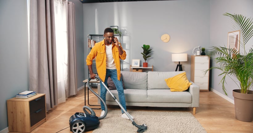 Man Vacuuming while Talking to Someone over the Phone